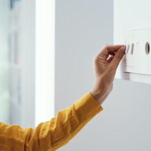 Woman checking settings on the boiler